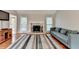 Comfortable living room featuring a fireplace, natural lighting, and hardwood floors at 6040 Carriage Dr, Cumming, GA 30028