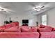 Bright living room with hardwood floors, large sectional, ceiling fans and lots of natural light at 6040 Carriage Dr, Cumming, GA 30028