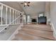 Inviting living room features a high ceiling, fireplace, and wood floors at 6040 Carriage Dr, Cumming, GA 30028