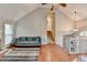 Open-concept living room featuring high ceilings, wood floors, and an inviting seating area at 6040 Carriage Dr, Cumming, GA 30028