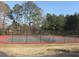 Community tennis courts enclosed with a fence, surrounded by mature trees at 6040 Carriage Dr, Cumming, GA 30028