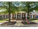 Classic brick clubhouse with white columns and manicured landscaping at entrance at 12120 Dancliff Trce, Alpharetta, GA 30009