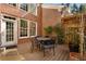 Inviting outdoor deck featuring a metal table and chairs, brick exterior, and a view of the surrounding landscape at 12120 Dancliff Trce, Alpharetta, GA 30009