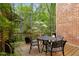 Charming wooden deck with outdoor seating, plants, and a serene view of the surrounding trees at 12120 Dancliff Trce, Alpharetta, GA 30009