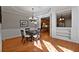 Elegant dining room with wainscoting and a view of the kitchen at 12120 Dancliff Trce, Alpharetta, GA 30009