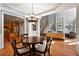 Open dining room with hardwood floors and chandelier, adjacent to kitchen at 12120 Dancliff Trce, Alpharetta, GA 30009