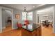 Bright eat-in kitchen with hardwood floors, a center island, and views of dining room at 12120 Dancliff Trce, Alpharetta, GA 30009