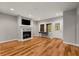 Open-concept living room with hardwood floors and a fireplace with mantle at 12120 Dancliff Trce, Alpharetta, GA 30009