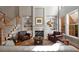 Inviting living room with fireplace, built-ins, and large windows at 12120 Dancliff Trce, Alpharetta, GA 30009