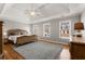 Spacious main bedroom featuring a tray ceiling, hardwood floors, and large windows at 12120 Dancliff Trce, Alpharetta, GA 30009