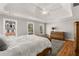 Well-lit main bedroom featuring a tray ceiling, hardwood floors, and large windows at 12120 Dancliff Trce, Alpharetta, GA 30009