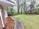 A spacious backyard with a walkway leading to a tree-lined area at 1256 E Piedmont Rd, Marietta, GA 30062