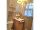 A cozy bathroom featuring a vanity and a window with patterned curtains at 1256 E Piedmont Rd, Marietta, GA 30062