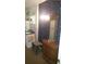 Compact bathroom featuring tiled walls, vanity, and floral wallpaper at 1256 E Piedmont Rd, Marietta, GA 30062