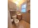A full bathroom with a toilet, vanity, mirror, and tiled walls and floors at 1256 E Piedmont Rd, Marietta, GA 30062