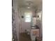 Compact bathroom featuring tiled walls and a sink vanity at 1256 E Piedmont Rd, Marietta, GA 30062