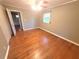 A spacious bedroom with hardwood floors, a ceiling fan, and natural light from the window at 1256 E Piedmont Rd, Marietta, GA 30062