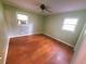 A bedroom featuring hardwood floors and a window with an air conditioning unit at 1256 E Piedmont Rd, Marietta, GA 30062
