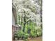 A charming home exterior with lush trees and a beautiful white dogwood in full bloom at 1256 E Piedmont Rd, Marietta, GA 30062