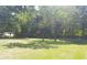 Expansive front yard features lush green grass and mature trees, creating a serene setting at 1256 E Piedmont Rd, Marietta, GA 30062