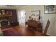 Cozy living room featuring a brick fireplace, wood floors, and antique piano at 1256 E Piedmont Rd, Marietta, GA 30062
