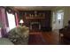 A cozy living room featuring a brick fireplace and a floral patterned sofa at 1256 E Piedmont Rd, Marietta, GA 30062