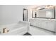 Bright bathroom showcasing a soaking tub, double vanity with ample storage, and marble flooring at 3717 Silvery Way, Powder Springs, GA 30127