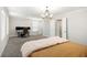 Spacious bedroom featuring plush carpet, a modern chandelier, and a dedicated workspace with multiple monitors at 3717 Silvery Way, Powder Springs, GA 30127