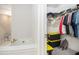 Walk-in closet offering plenty of storage space with shelving, plus access to a full bathroom and tub at 3717 Silvery Way, Powder Springs, GA 30127