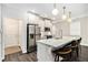 Kitchen featuring a large island with seating, stainless steel refrigerator, and modern lighting fixtures at 3717 Silvery Way, Powder Springs, GA 30127