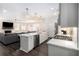 Bright, open kitchen features stainless steel appliances and a large island, seamlessly flowing into the living area at 3717 Silvery Way, Powder Springs, GA 30127