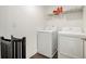 Functional laundry room with modern washer and dryer units, and a wire shelf above at 3717 Silvery Way, Powder Springs, GA 30127