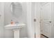 Compact powder room featuring a pedestal sink and a minimalist design at 3717 Silvery Way, Powder Springs, GA 30127