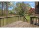 Backyard view from the wooden deck, showing fenced lawn and trees at 570 Bell Se Rd, Conyers, GA 30094