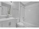 A clean bathroom with a white vanity, toilet, mirror, shower and bathtub with a shower curtain at 570 Bell Se Rd, Conyers, GA 30094