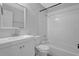 A clean bathroom with a white vanity, mirror, toilet, and tiled shower/tub combination at 570 Bell Se Rd, Conyers, GA 30094