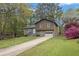 Split-level home with a well-manicured lawn, driveway, and blossoming azaleas at 570 Bell Se Rd, Conyers, GA 30094