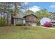 Split-level home with a charming front yard, a one-car garage, and blossoming azaleas at 570 Bell Se Rd, Conyers, GA 30094
