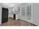 Bright kitchen featuring white cabinets, stainless steel appliances, and sliding glass doors to the backyard at 570 Bell Se Rd, Conyers, GA 30094