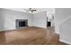 Bright living room featuring hardwood floors, a cozy fireplace, and a ceiling fan at 570 Bell Se Rd, Conyers, GA 30094