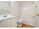 Bright bathroom with white cabinets, a single sink, a shower and tub combination, and wood-look vinyl flooring at 6028 Connaught Se Dr, Mableton, GA 30126
