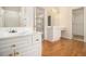Bathroom vanity with double sinks and a dressing table and a walk-in closet at 6028 Connaught Se Dr, Mableton, GA 30126