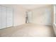 Neutral bedroom featuring plush carpet, light walls, a window, and dual closets, offering comfort and ample storage at 6028 Connaught Se Dr, Mableton, GA 30126