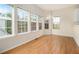 Bright dining room featuring hardwood floors and many windows showcasing the outdoors at 6028 Connaught Se Dr, Mableton, GA 30126