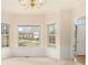 Cozy dining room featuring neutral carpet, bay windows, and a classic chandelier at 6028 Connaught Se Dr, Mableton, GA 30126
