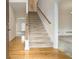 Bright foyer features hardwood floors, stairs with wood banister, and an entry to the living area at 6028 Connaught Se Dr, Mableton, GA 30126