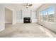 Open concept living room with a fireplace and built-in shelving next to an abundance of natural light at 6028 Connaught Se Dr, Mableton, GA 30126