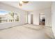 Sunny living room with an exit to an outdoor deck, an ensuite bath, and hardwood access to the kitchen at 6028 Connaught Se Dr, Mableton, GA 30126