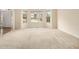 Spacious living room with neutral carpeting, bay windows, and ample natural light at 6028 Connaught Se Dr, Mableton, GA 30126