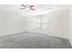Large bedroom with neutral gray walls, carpet, and a ceiling fan provides ample space at 6625 Story Cir, Norcross, GA 30093